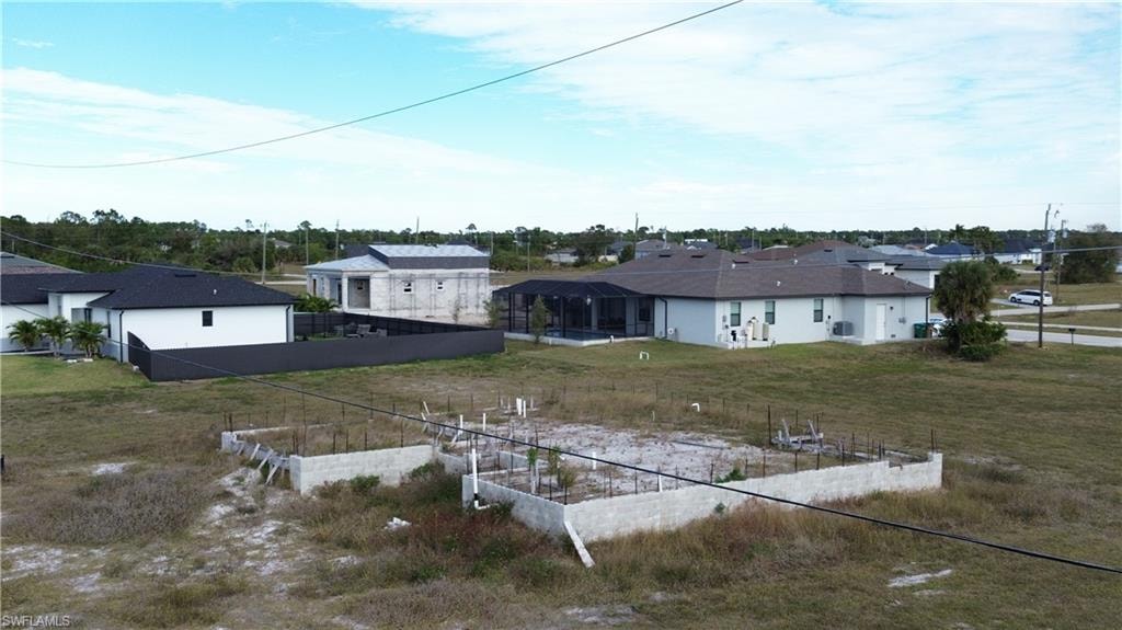 Back of house with a residential view and a vegetable garden