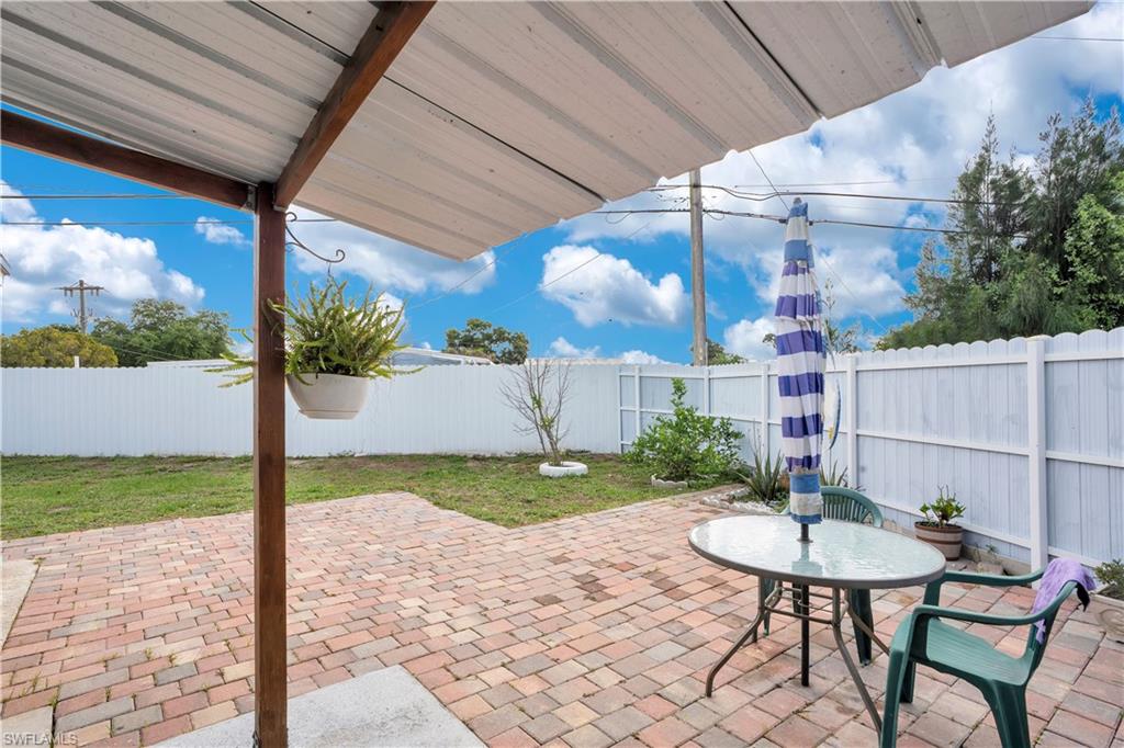 Fenced backyard with a patio and outdoor dining space