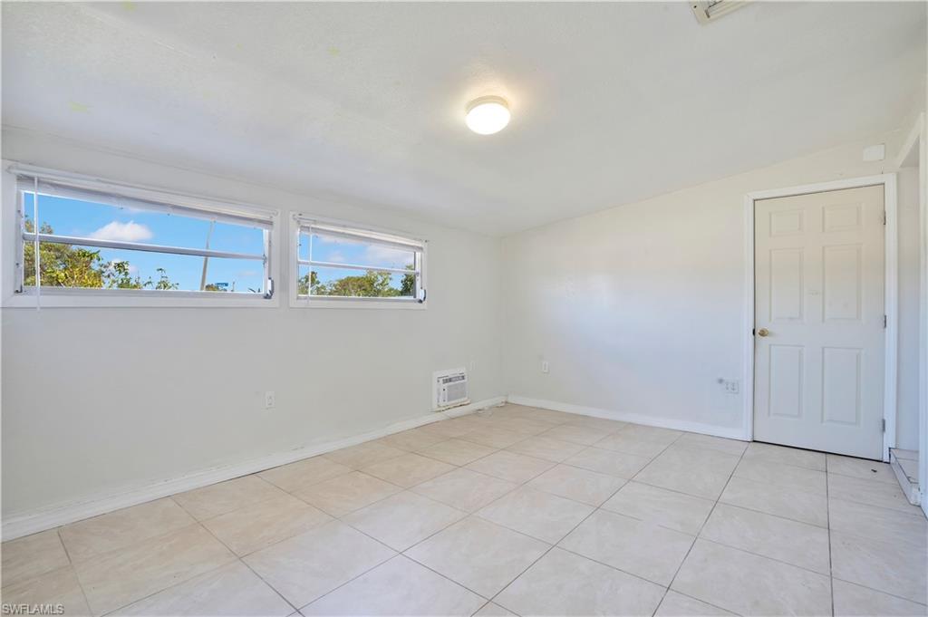 Unfurnished room with baseboards and light tile patterned floors