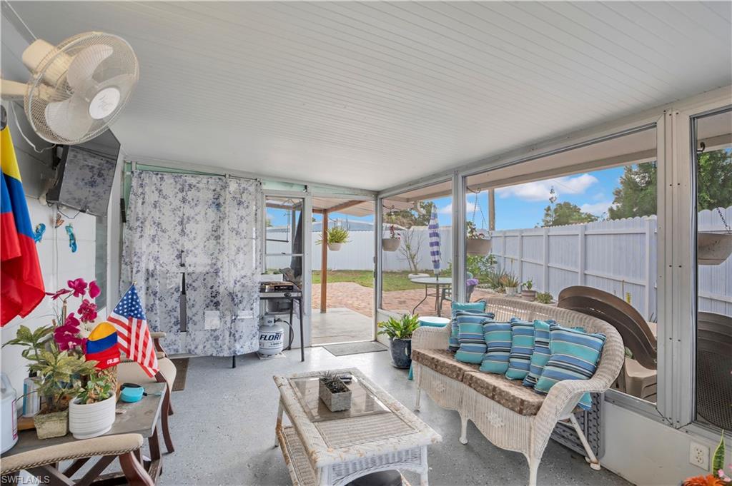 Sunroom with outdoor seating and a patio area