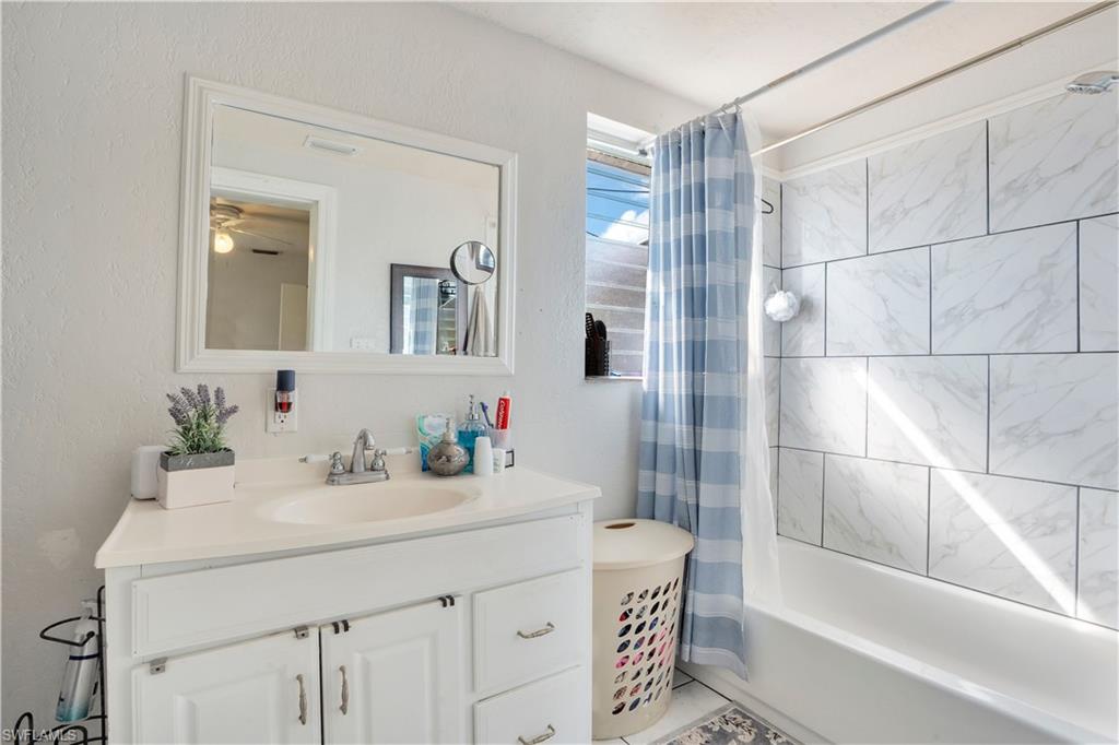 Bathroom with vanity and shower / bath combo