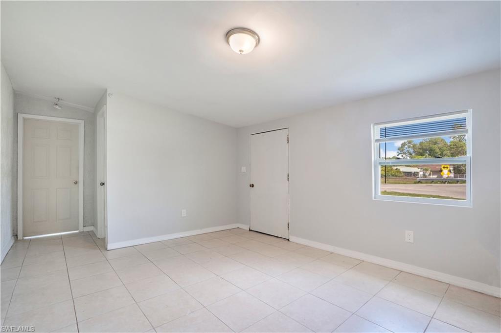 Unfurnished room with baseboards and light tile patterned floors
