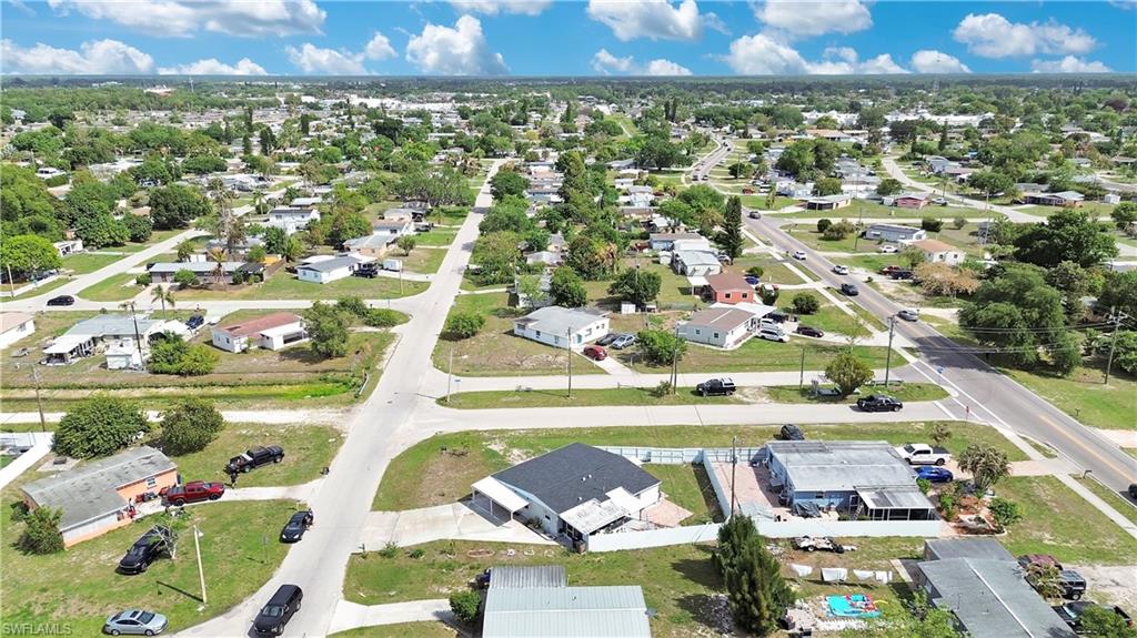 Aerial view of property and surrounding area with nearby suburban area
