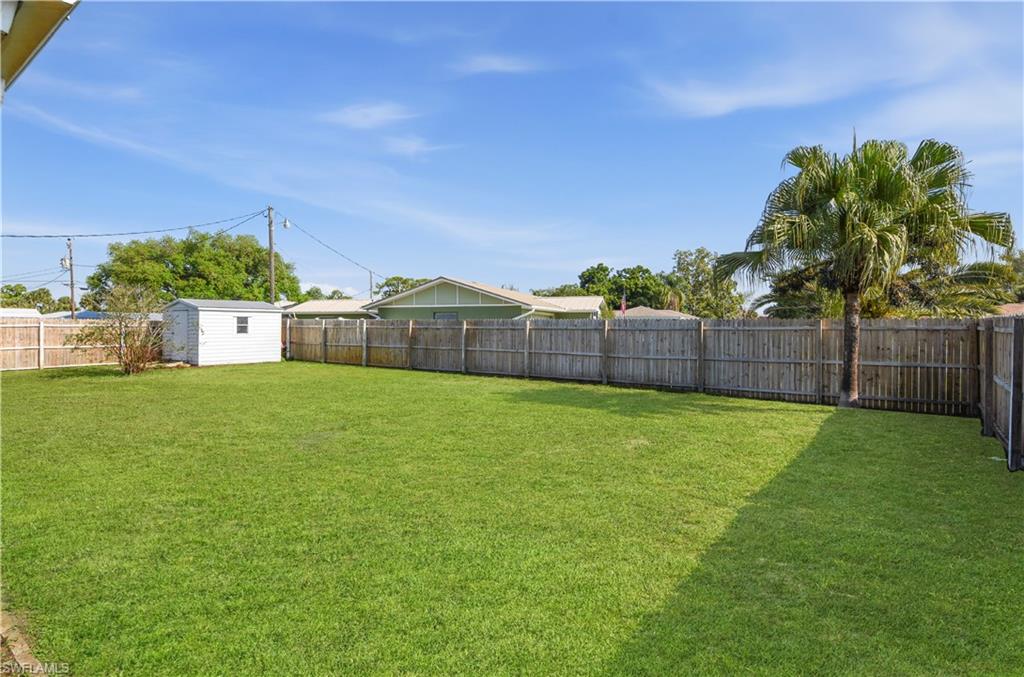 Fenced backyard with a storage shed
