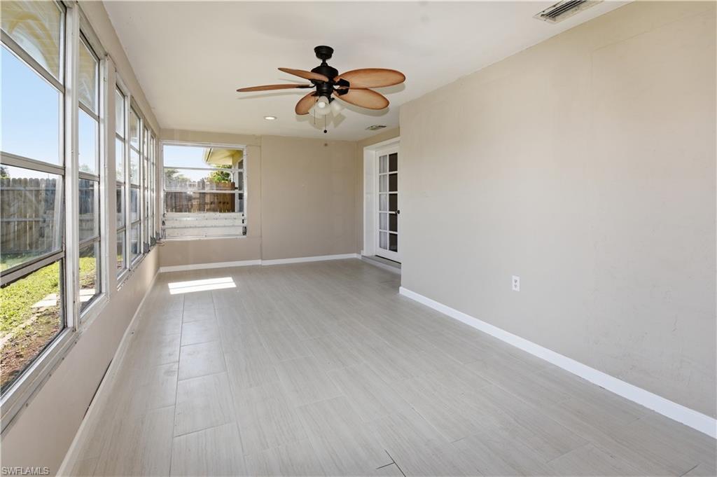 Unfurnished sunroom featuring a ceiling fan, wood finished floors, and recessed lighting