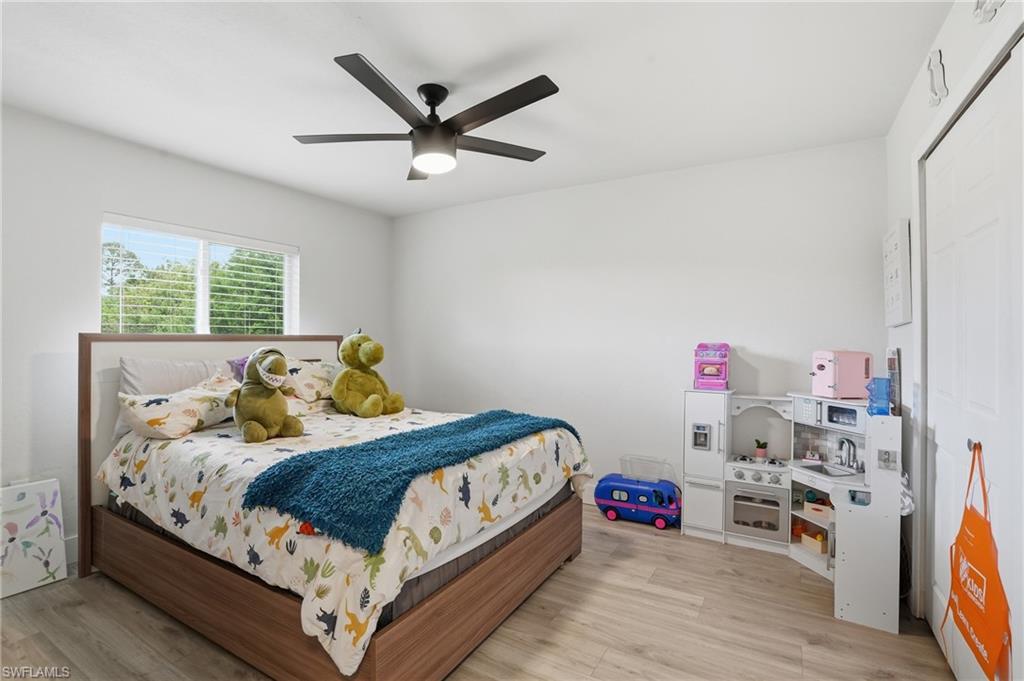 Bedroom with ceiling fan and light wood finished floors