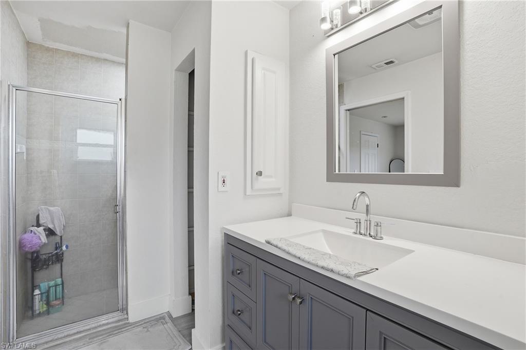 Bathroom with vanity and a shower stall