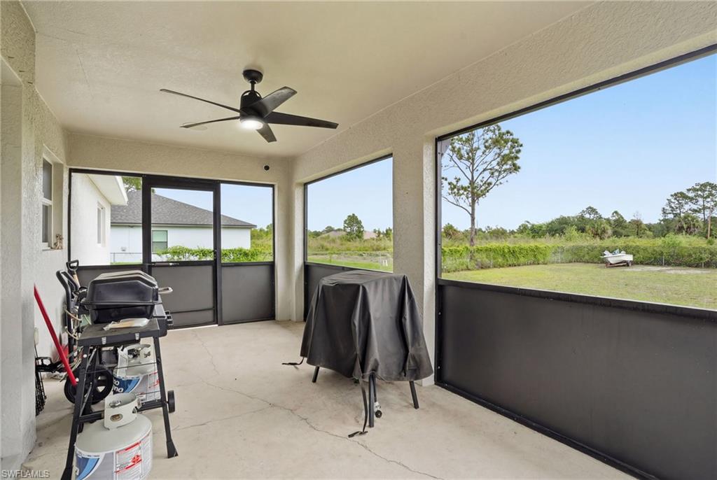 Sunroom featuring a ceiling fan