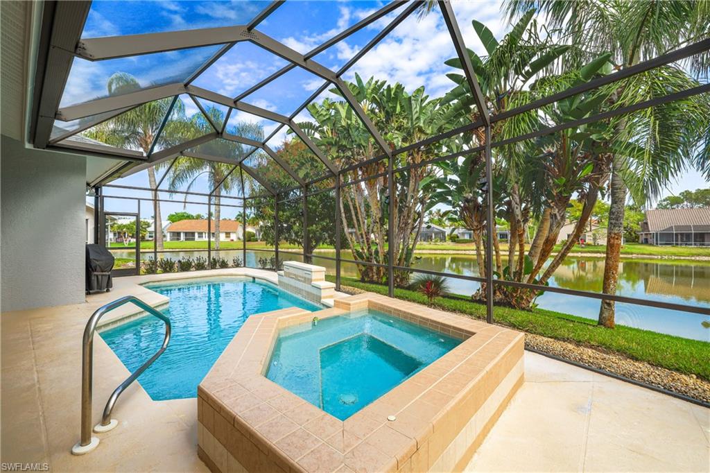 Swimming pool featuring a patio, an in-ground hot tub, a sunroom, a lanai, and a water view