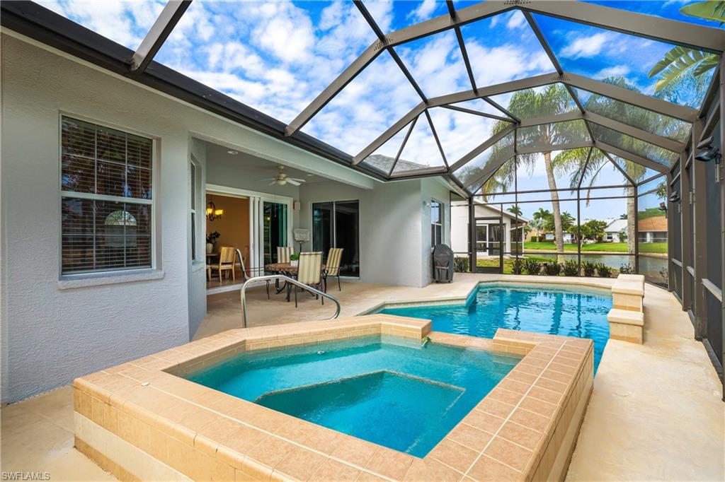 Integrated pool / hot tub featuring a sunroom, a patio, and a lanai
