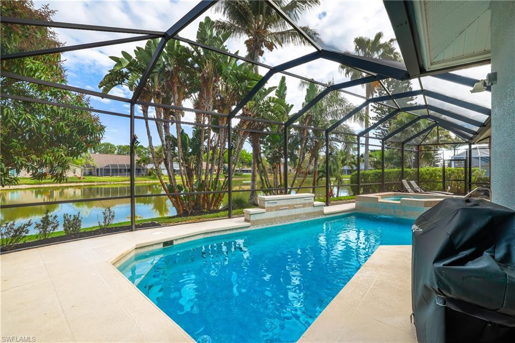 Integrated pool / spa featuring a sunroom, a grill, a patio, and a lanai
