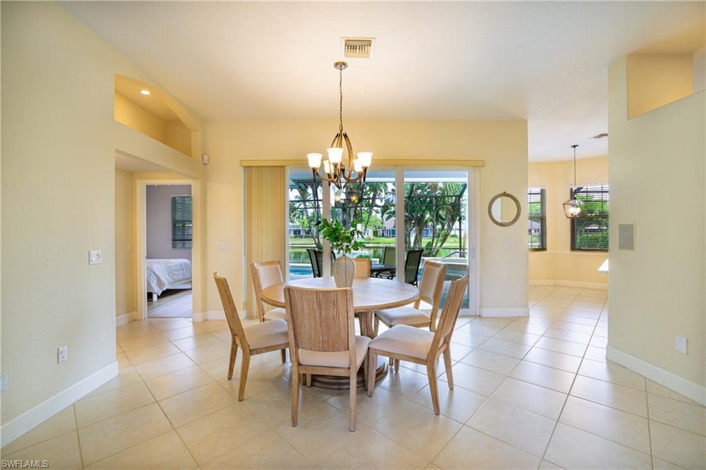 Dining room featuring a chandelier and light tile patterned floors