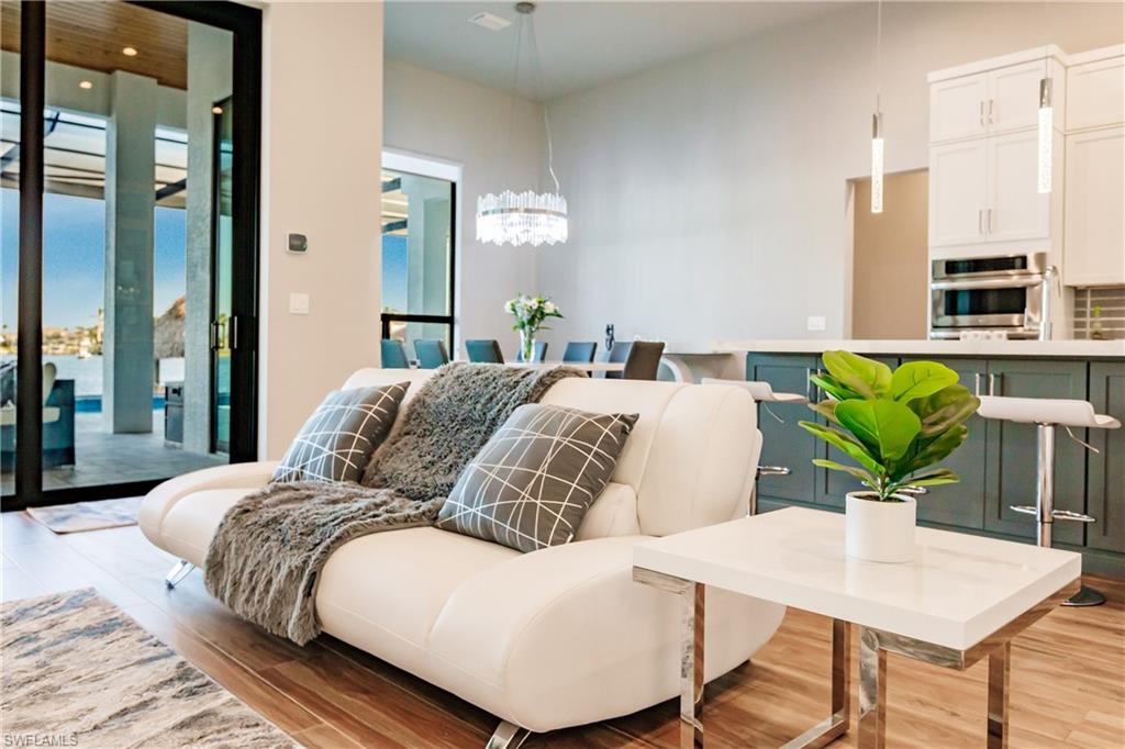 Living room with light wood-style floors and a chandelier