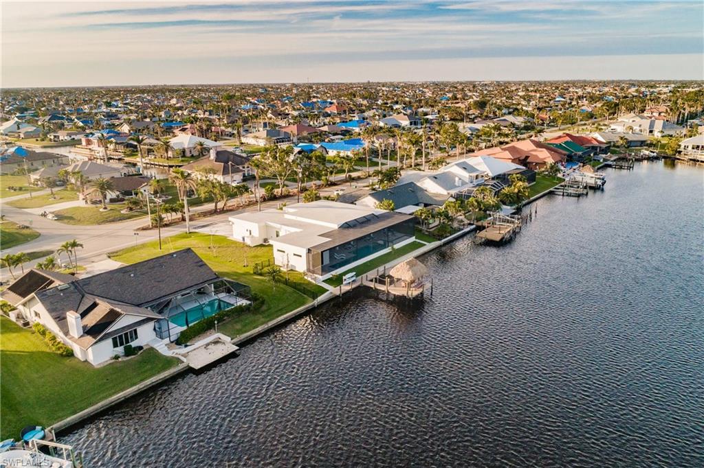 Aerial view of residential area featuring a nearby body of water