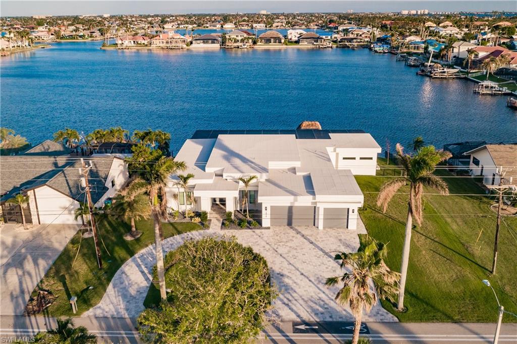 Aerial perspective of suburban area featuring a nearby body of water