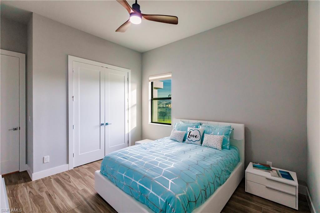 Bedroom with wood finished floors, a closet, and ceiling fan