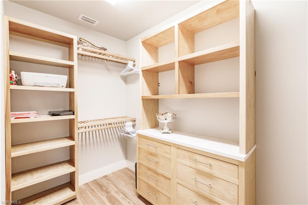 Spacious closet with light wood-style floors