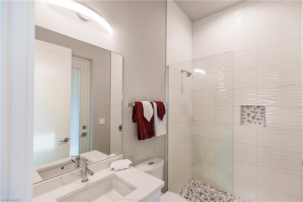 Bathroom with a stall shower and vanity
