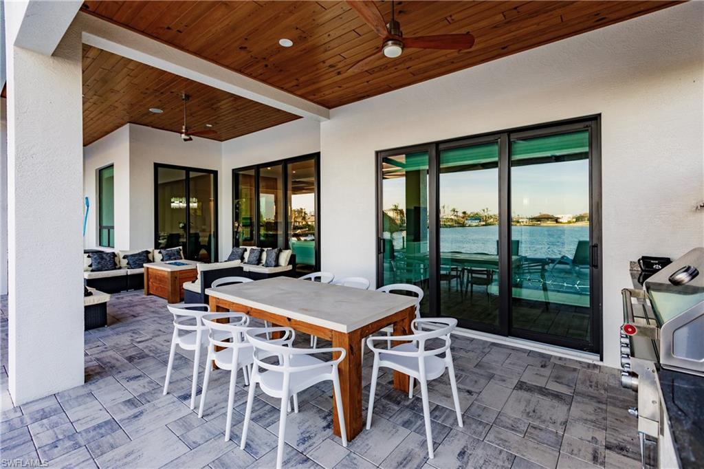 View of patio featuring a ceiling fan, an outdoor living space, and outdoor dining space