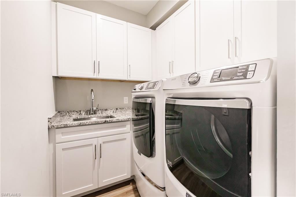 Laundry room with washing machine and clothes dryer and cabinet space