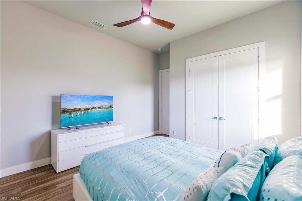 Bedroom with wood finished floors, a closet, and a ceiling fan