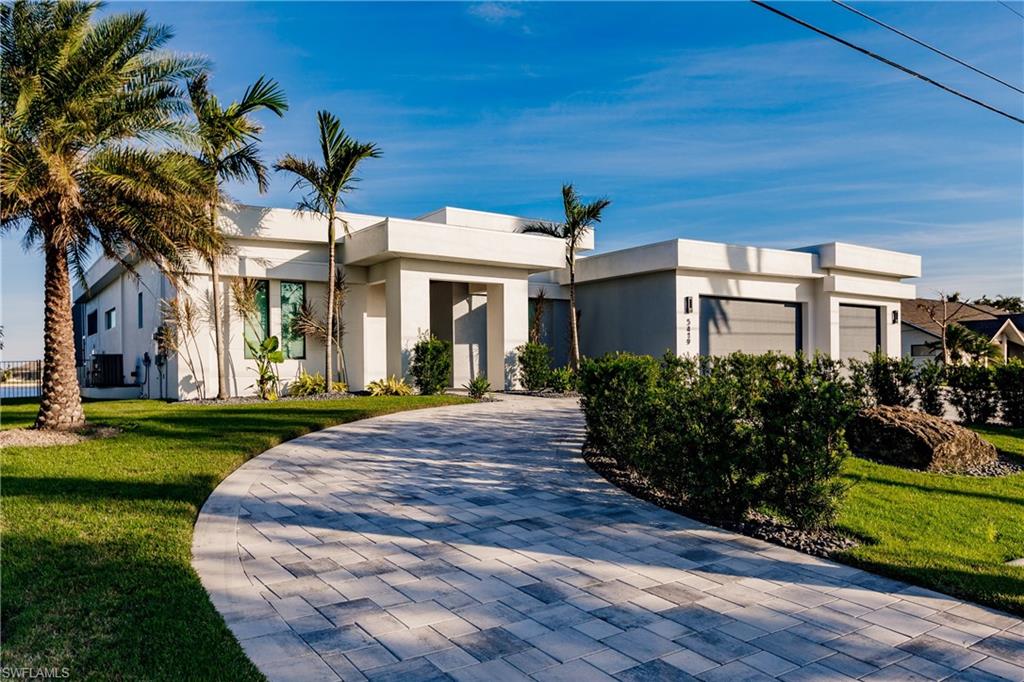 Contemporary home featuring stucco siding and a front yard