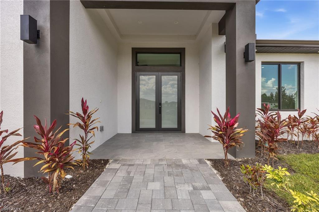 Property entrance with french doors and stucco siding