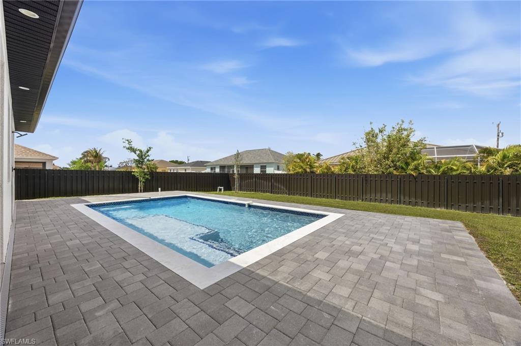 View of pool with a fenced backyard and patio surround