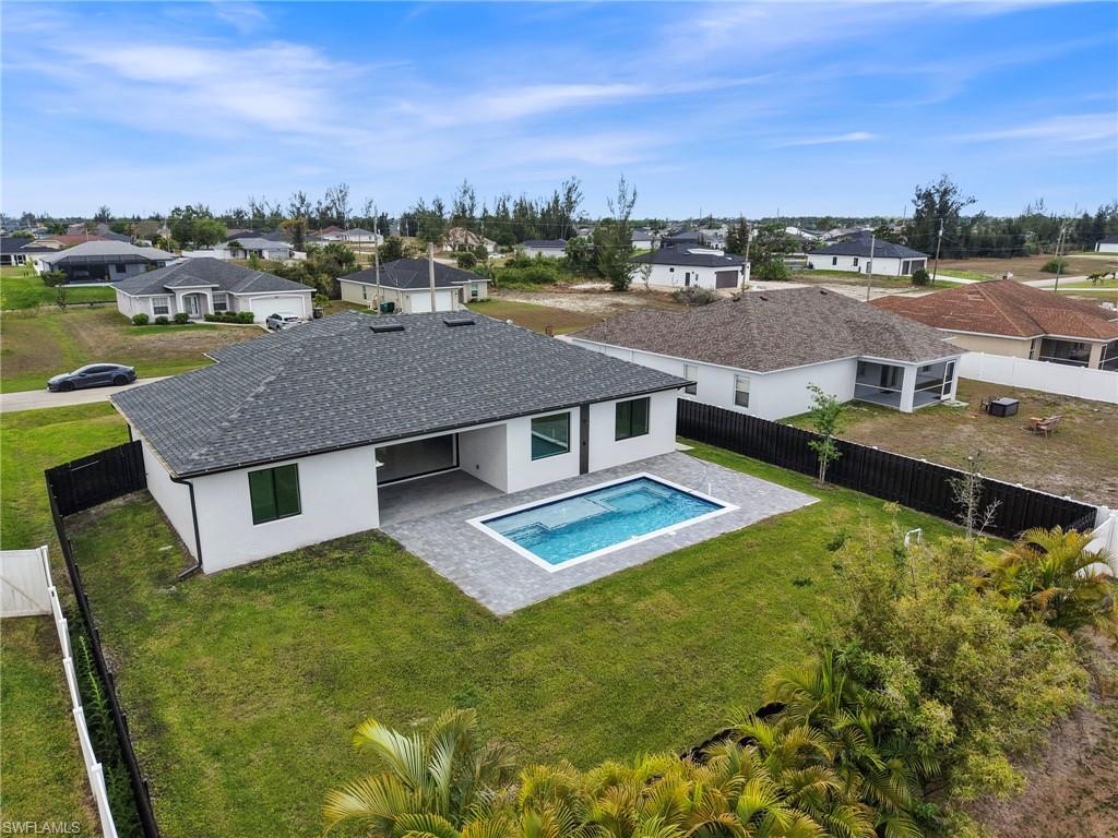 Back of property featuring a patio, a residential view, a fenced backyard, and stucco siding