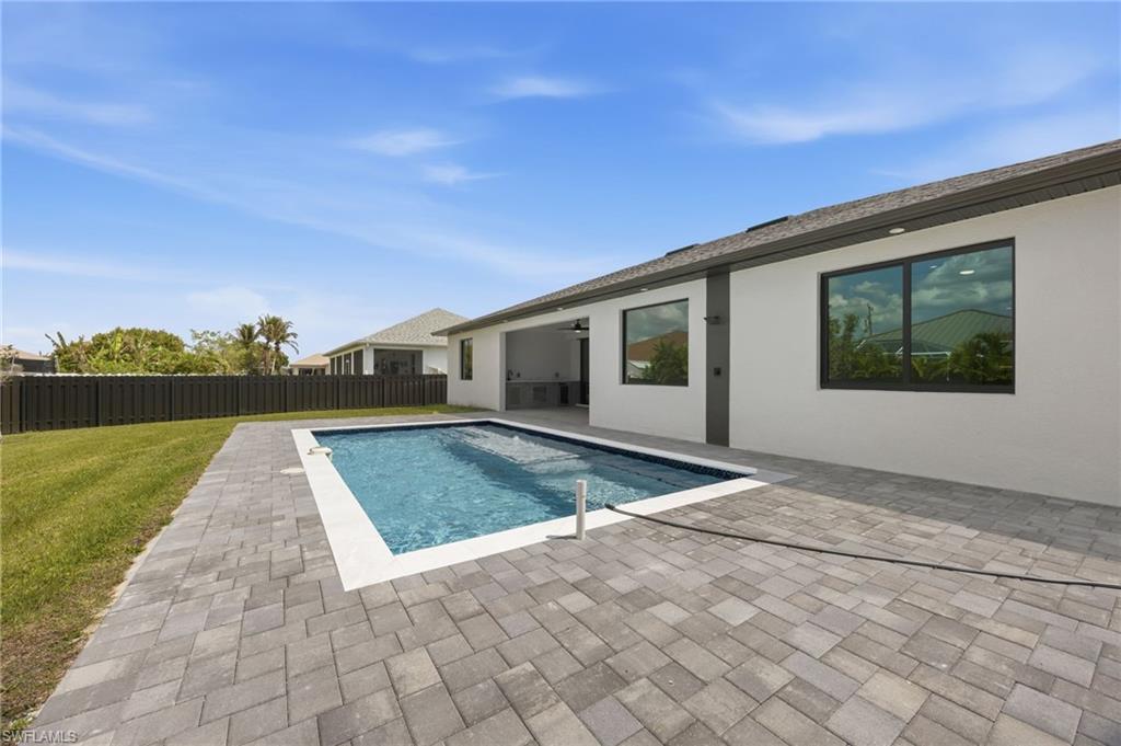 View of pool featuring patio surround and a fenced backyard