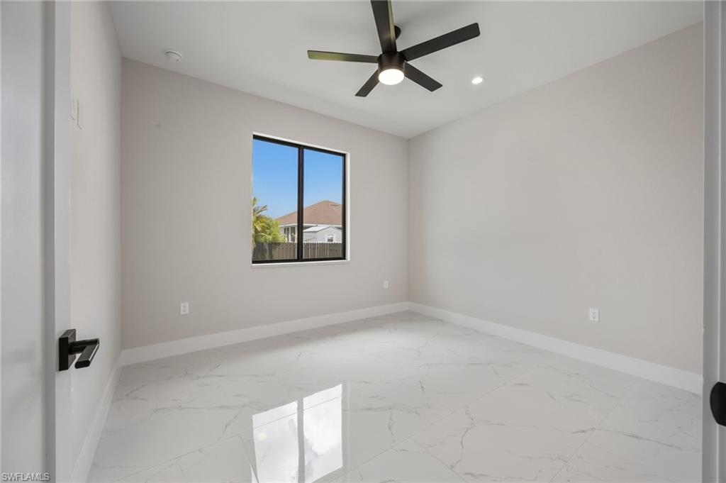 Unfurnished room featuring light marble finish floors, ceiling fan, and recessed lighting