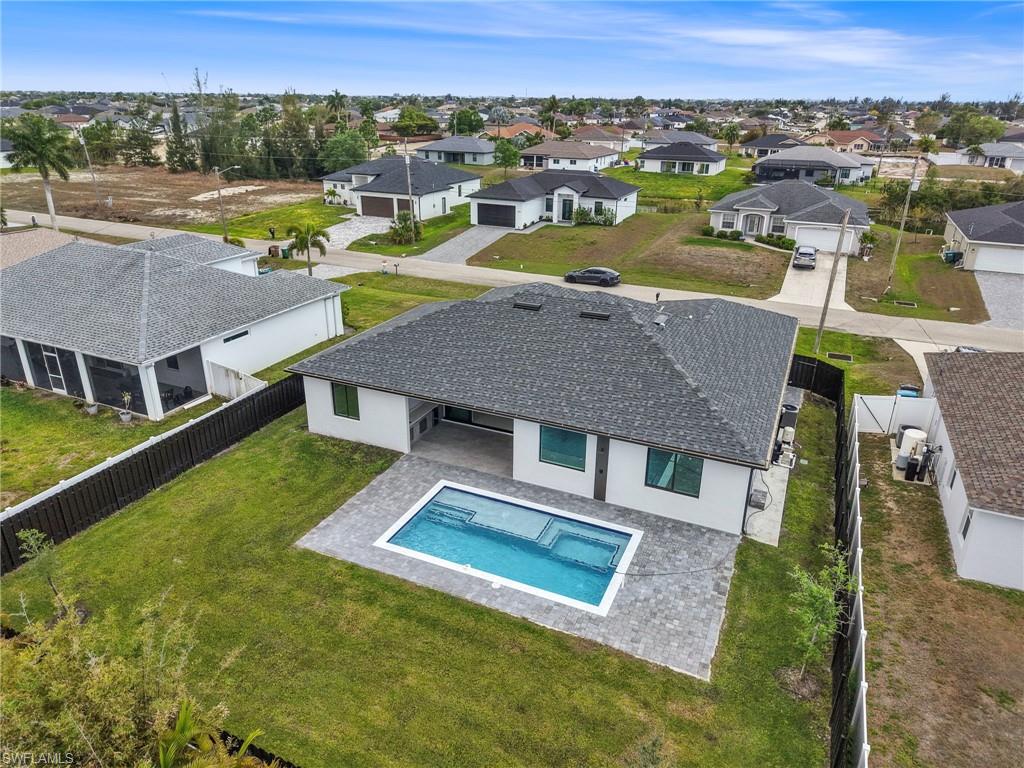 Aerial perspective of suburban area featuring a pool
