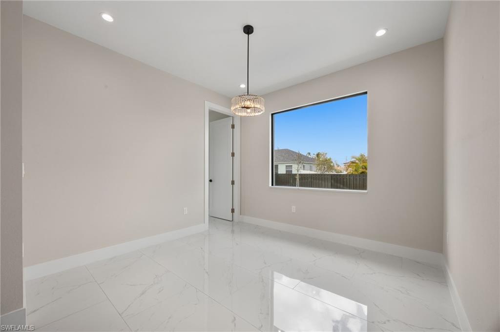 Unfurnished room with light marble finish floors and recessed lighting