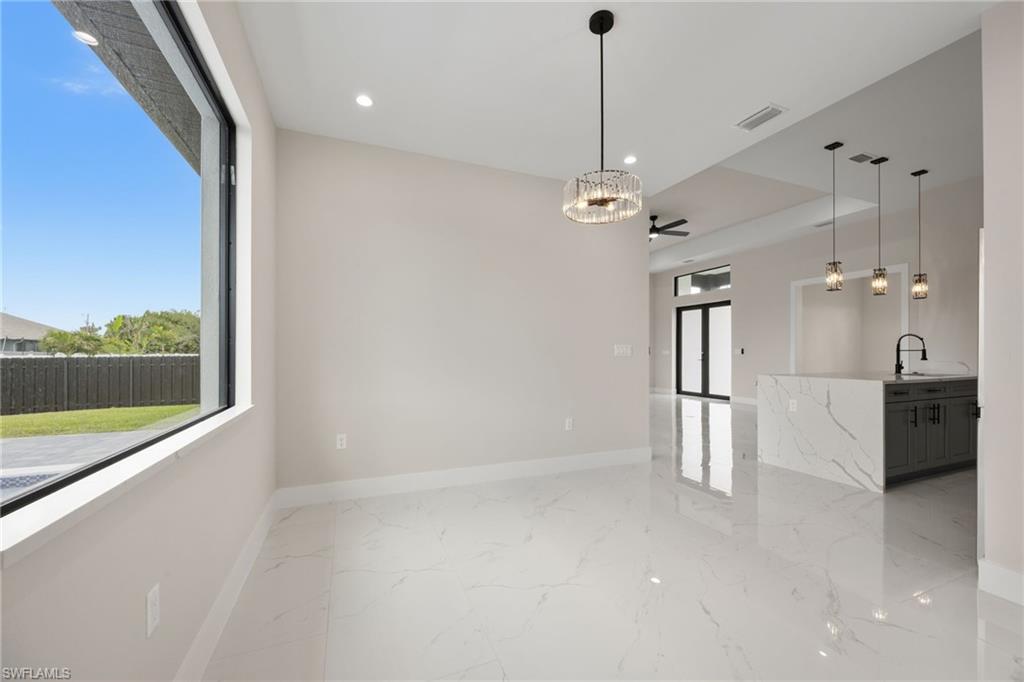Unfurnished dining area with light marble finish floors, recessed lighting, and a ceiling fan
