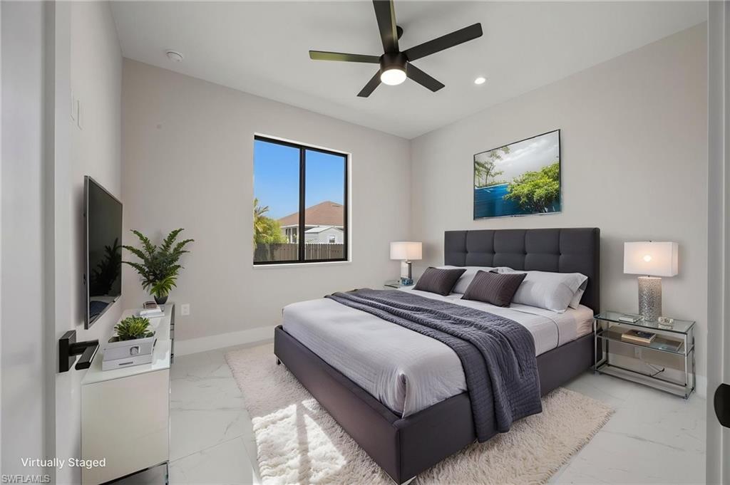 Bedroom featuring light marble finish flooring, ceiling fan, and recessed lighting