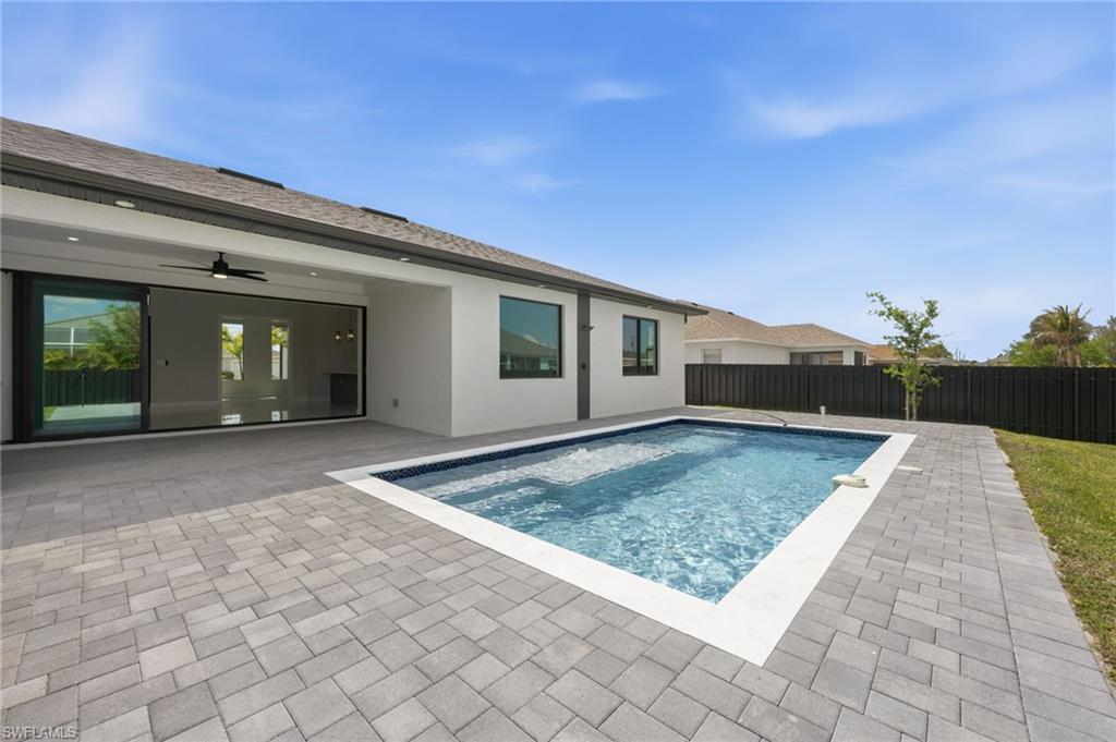 View of swimming pool with a fenced backyard and patio surround