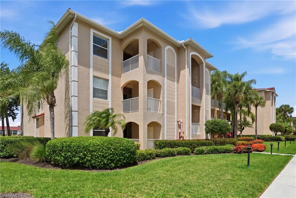 The property features a stucco exterior with multiple balconies and arched architectural details