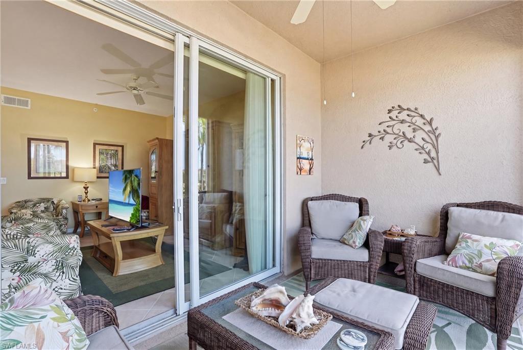 The property features a private covered balcony with outdoor seating, providing an inviting space for relaxation