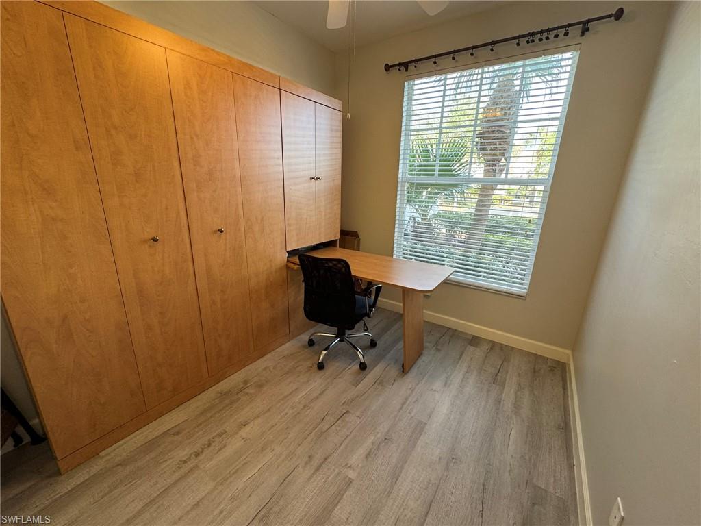 furnished office with ceiling fan and light wood-type flooring