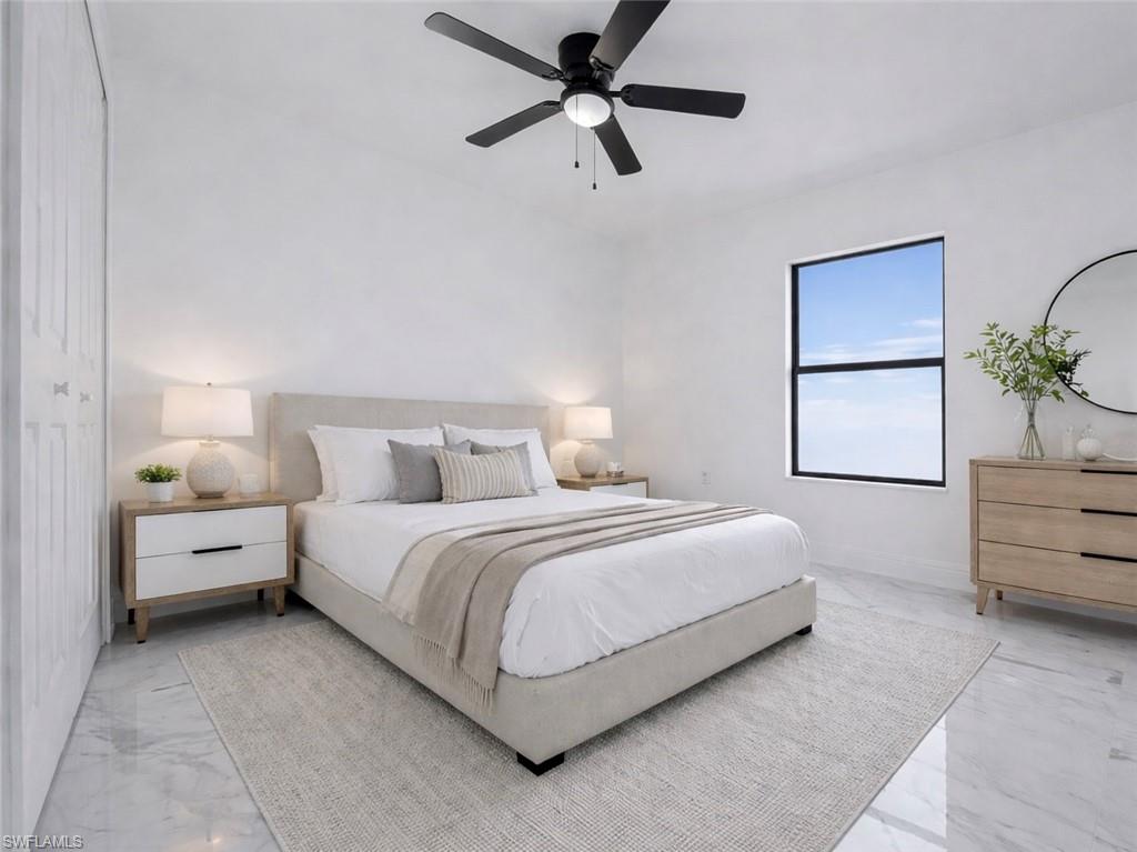 Bedroom with a ceiling fan and baseboards