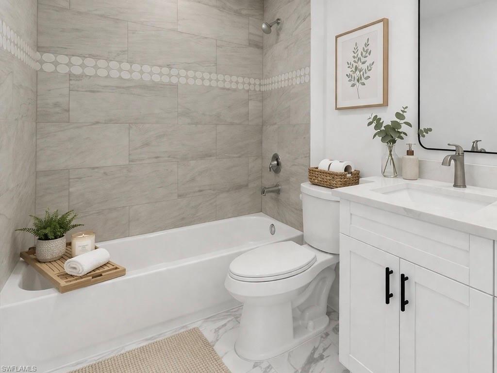 Full bathroom with vanity, shower / bathtub combination, and light marble finish flooring