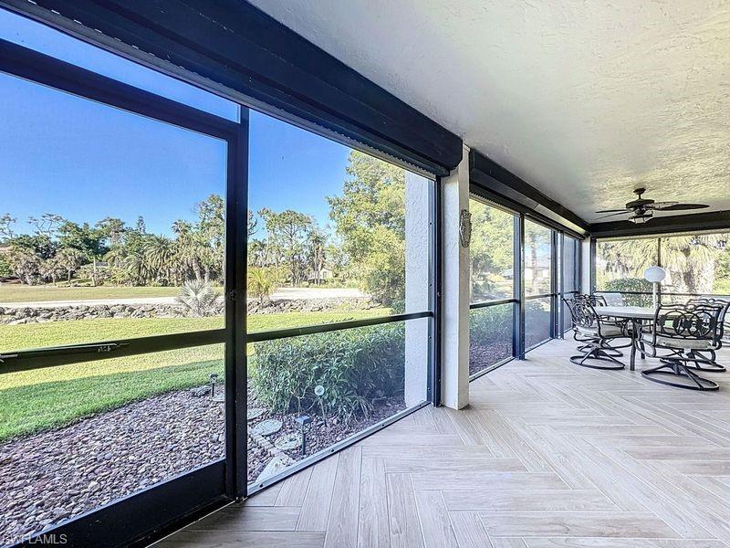 Unfurnished sunroom with ceiling fan