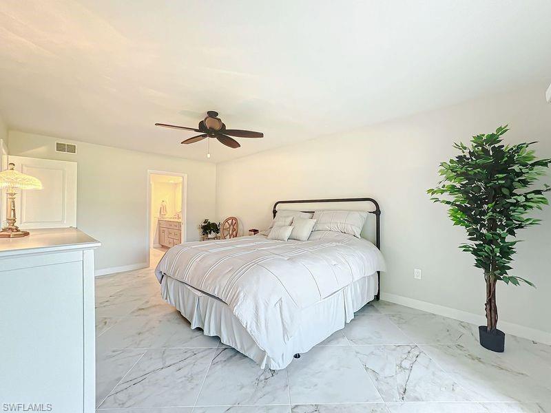 Bedroom with ceiling fan and ensuite bathroom