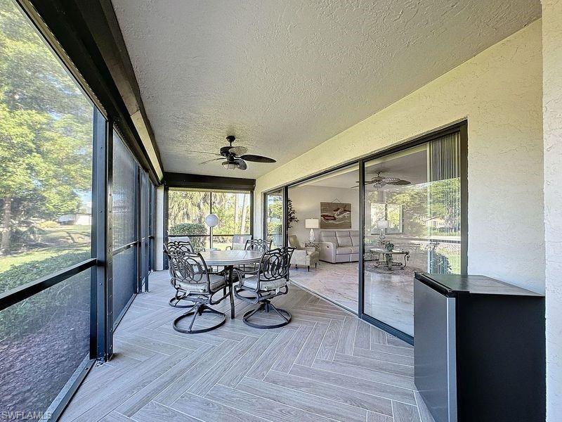 Unfurnished sunroom featuring ceiling fan