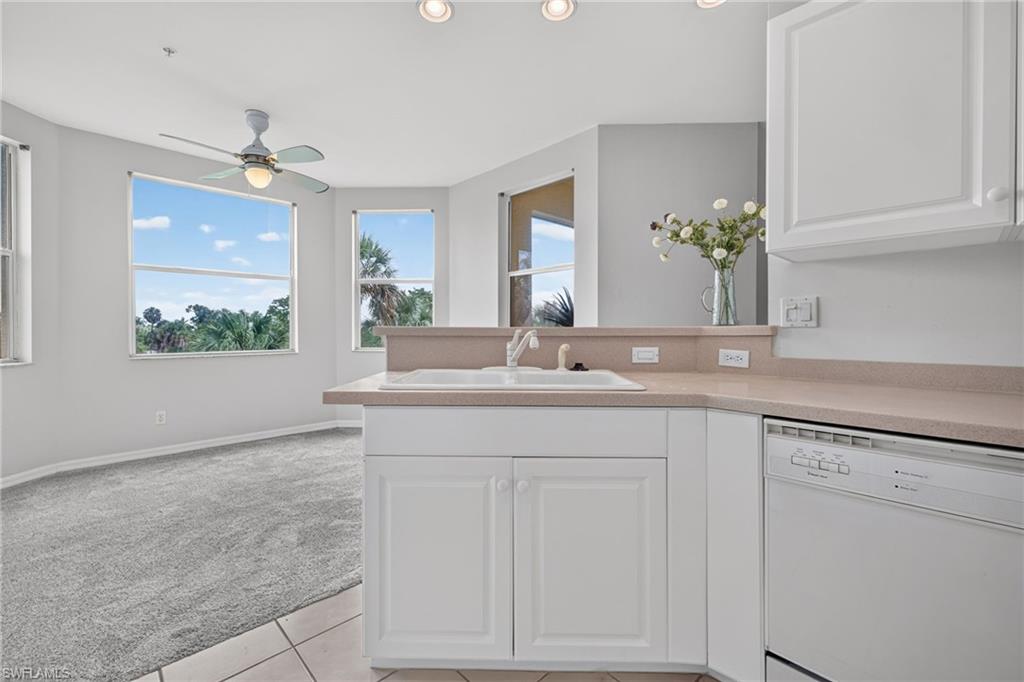 Open kitchen to dining with bay windows