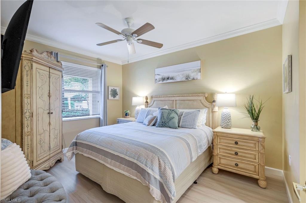 Bedroom with ornamental molding and light wood-type flooring