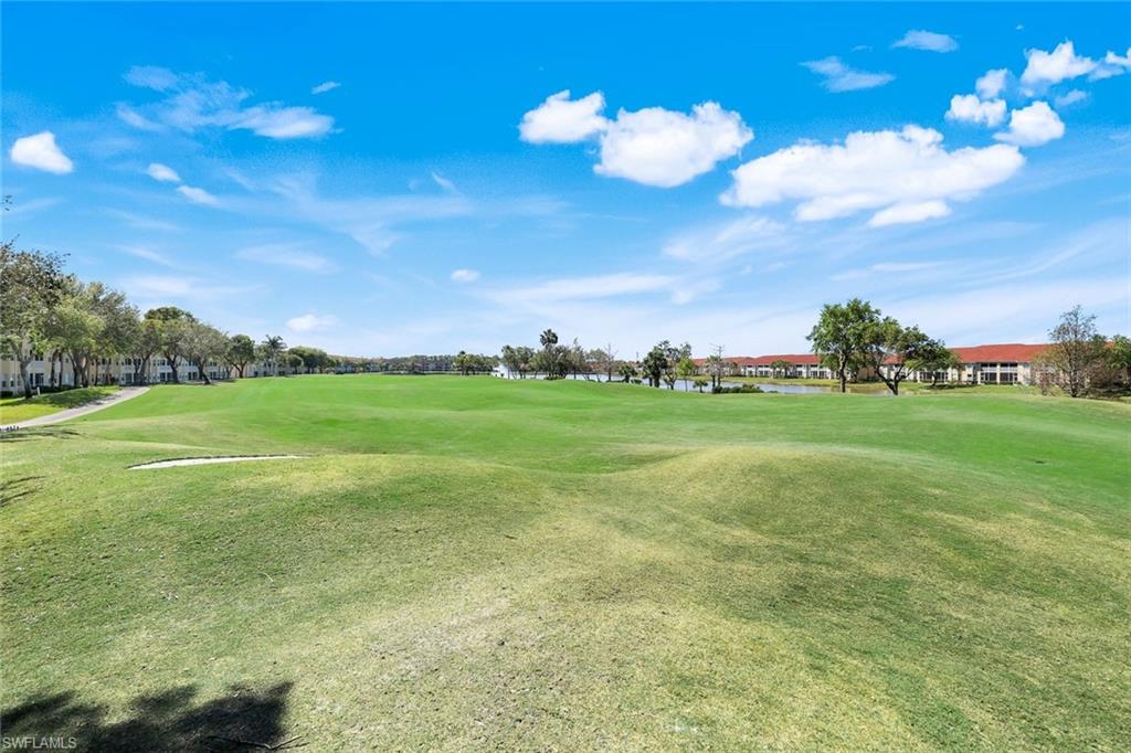 View of home's community featuring golf course view and a yard