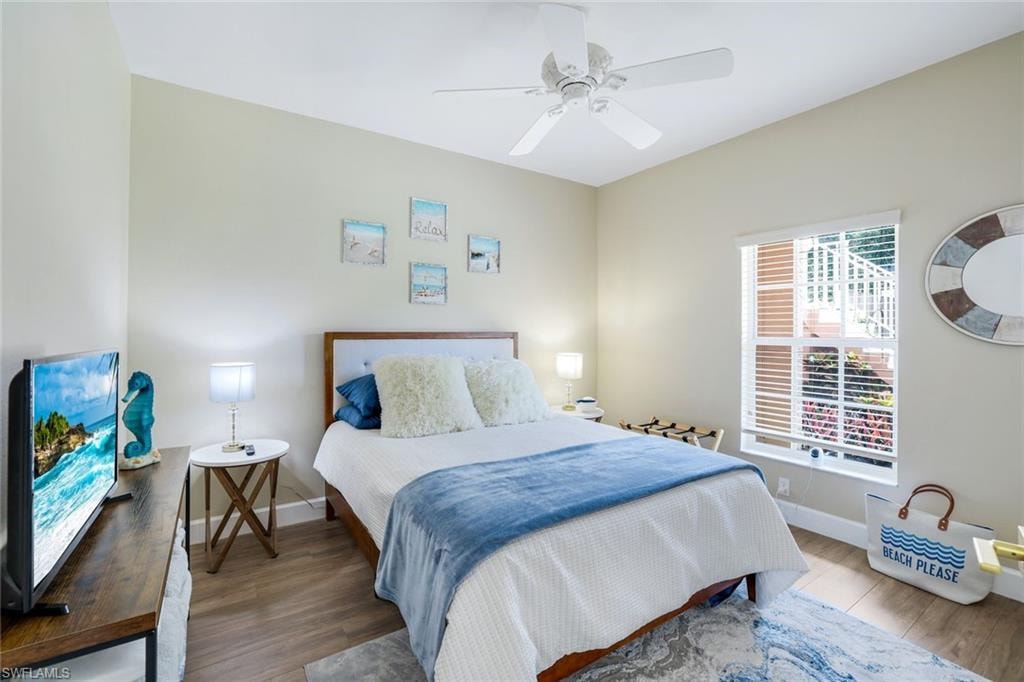 Bedroom with baseboards, wood finished floors, and ceiling fan