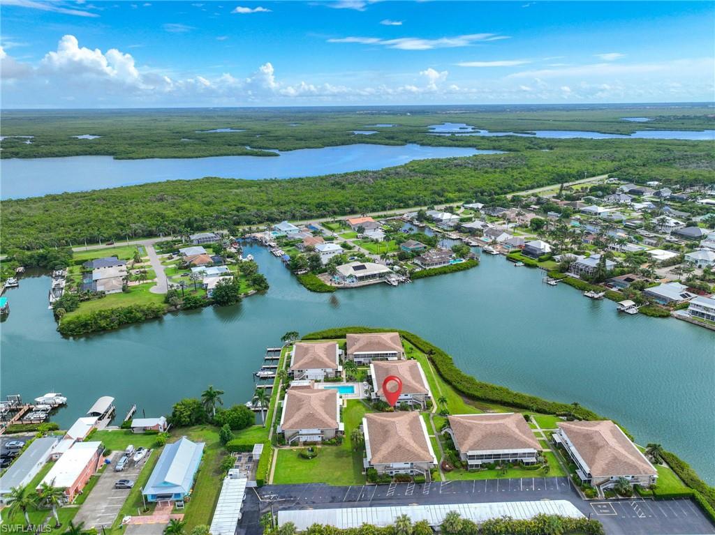 Waterfront community featuring multiple buildings with private boat docks and a central swimming pool