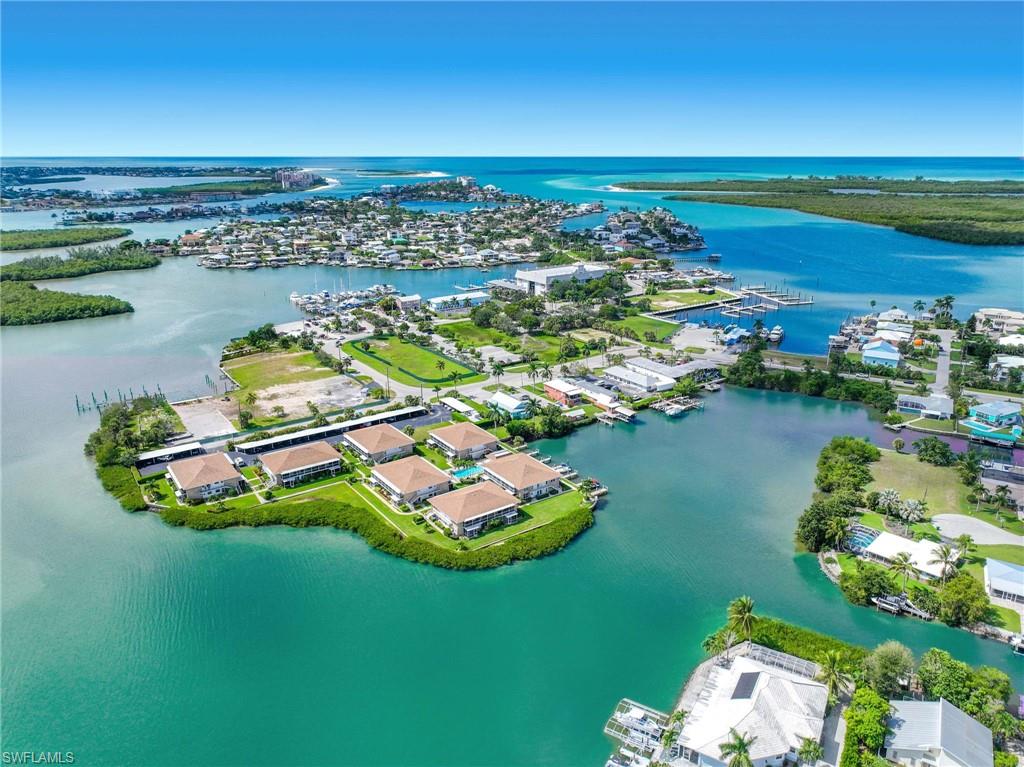 Panoramic aerial showcasing a coastal community with multiple properties